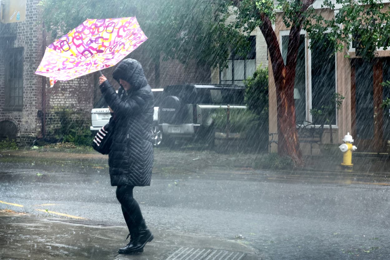 A pedestrian carries an umbrella during hard rain from Hurricane Ian, in Charleston, S.C., on Friday. on September 30, 2022