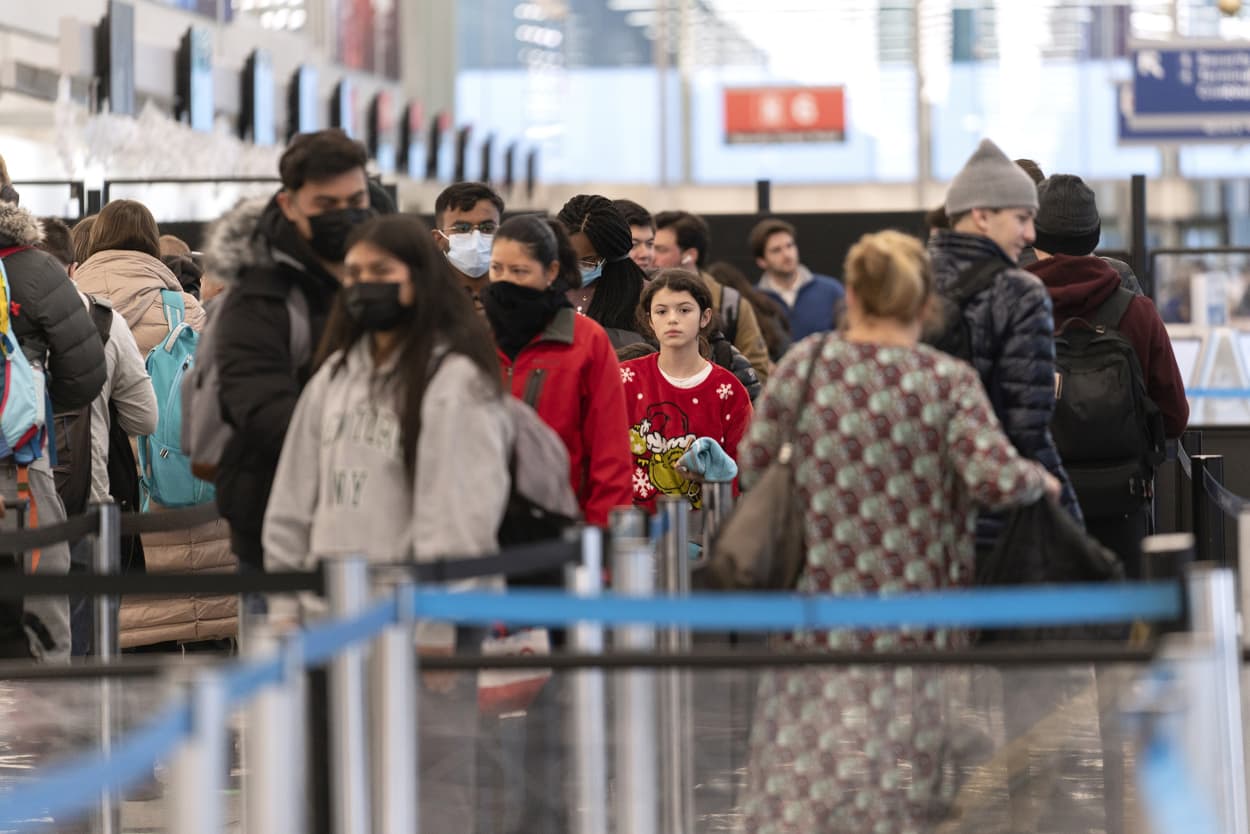 People wait in a security line at O'Hare International Airport Wednesday, Dec. 21, 2022, in Chicago.