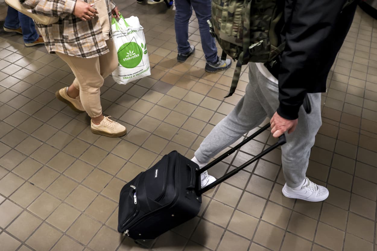 Travelers walk through LaGuardia Airport's Terminal A, Wednesday, Dec. 21, 2022, in New York. (AP Photo/Julia Nikhinson)
