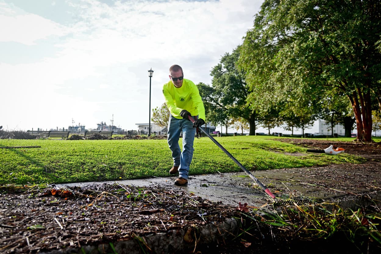 Kenny Wiggins works to clean city sidewalks around Waterfront Park in Charleston, S.C. following Tropical Storm Idalia on Aug. 31, 2023.