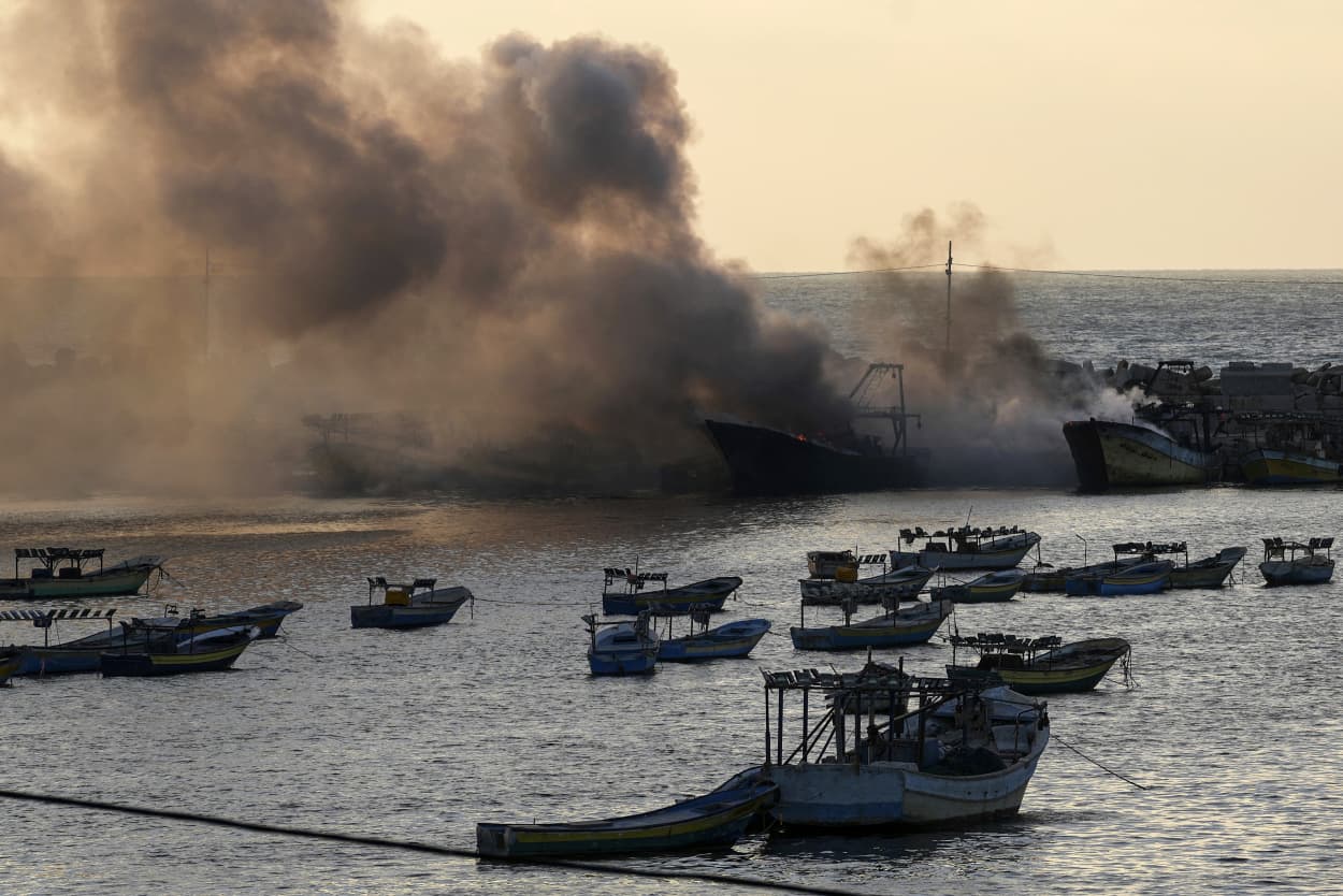 Smoke rises from burning fishing boats caused by an Israeli airstrike at the seaport in Gaza.