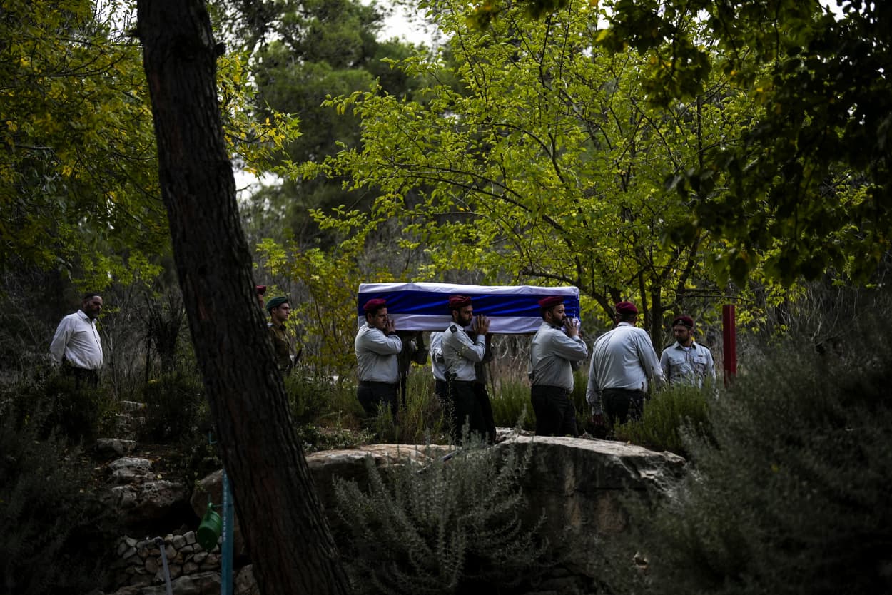 Israeli soldiers carry the flag-covered coffin of Maj. Tal Cohen during his funeral at the Givat Shaul cemetery in Jerusalem.