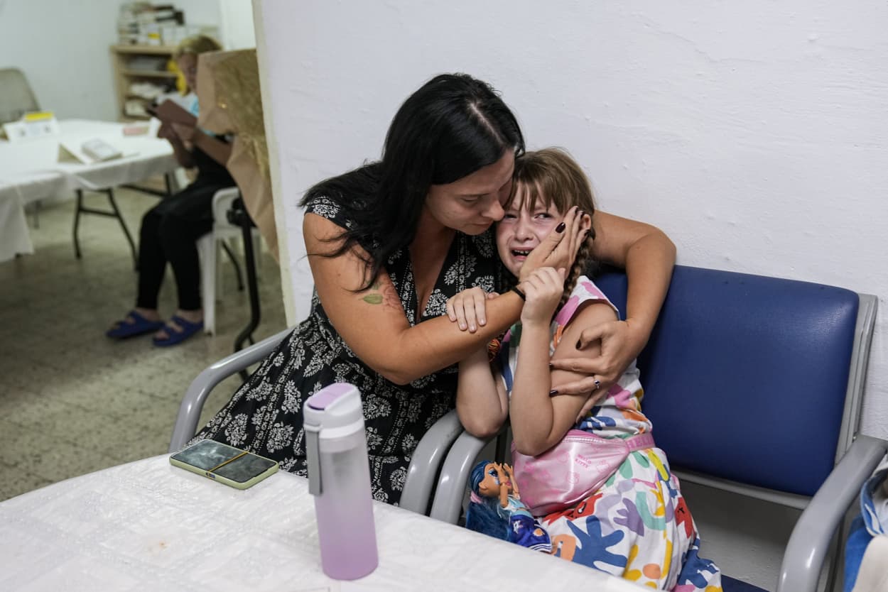 Israelis take cover in a shelter in Ashkelon as a siren warns of incoming rockets fired from Gaza on Oct. 10, 2023.