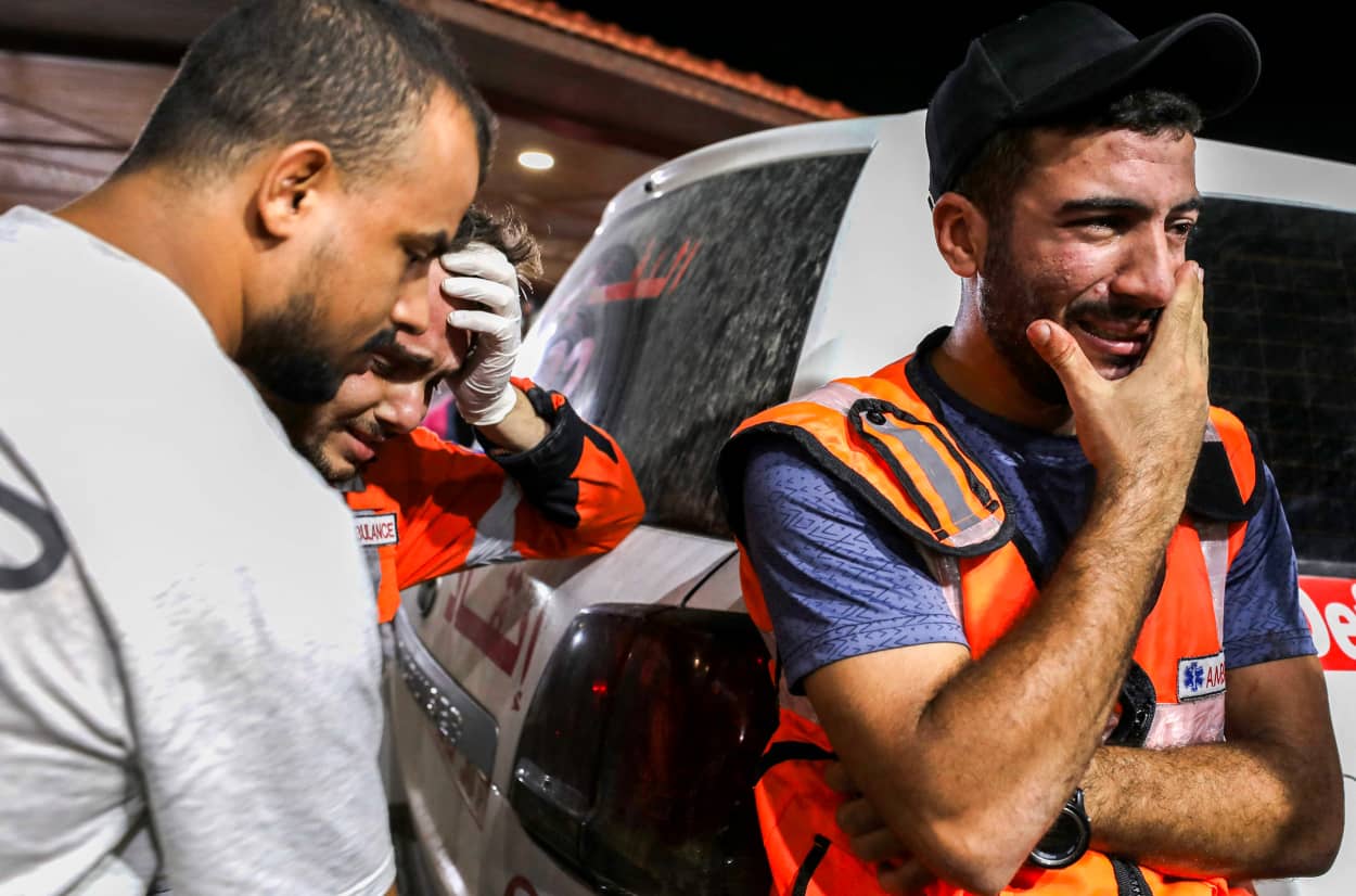 Palestinian paramedics cry outside Al-Shifa hopsital in Gaza City.
