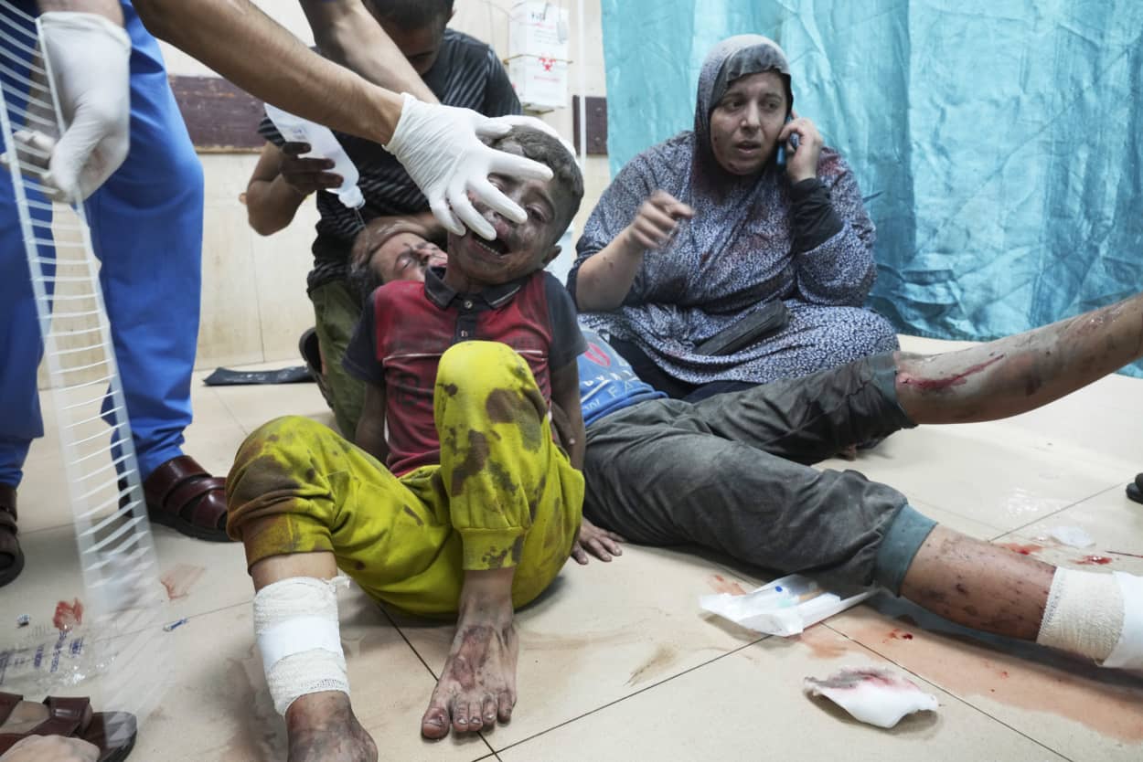 Palestinians wounded in an Israeli bombardment wait for treatment in a hospital