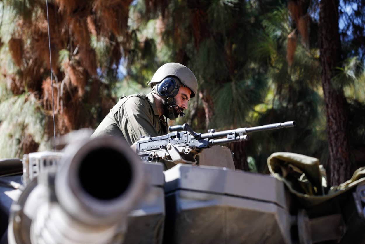 An Israeli soldier mans a Merkava tank positioned in the Upper Galilee area near the Lebanon border.