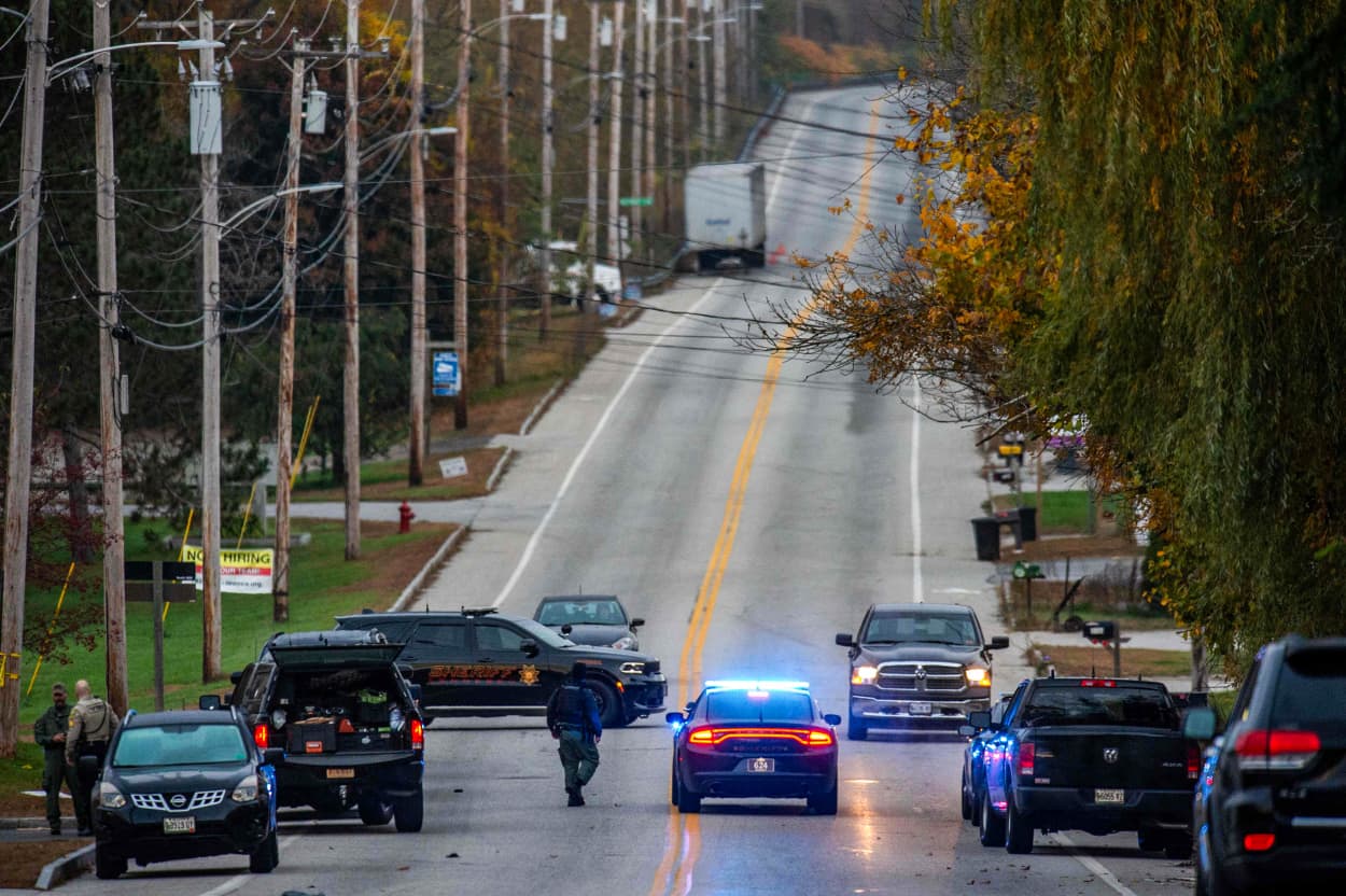 Police patrol at Schemengees Bar, the day after a mass shooting, in Lewiston, Maine.