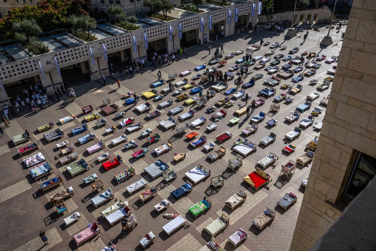 Image: The Empty Beds Installation which contains 230 beds and bassinets representing the hostages