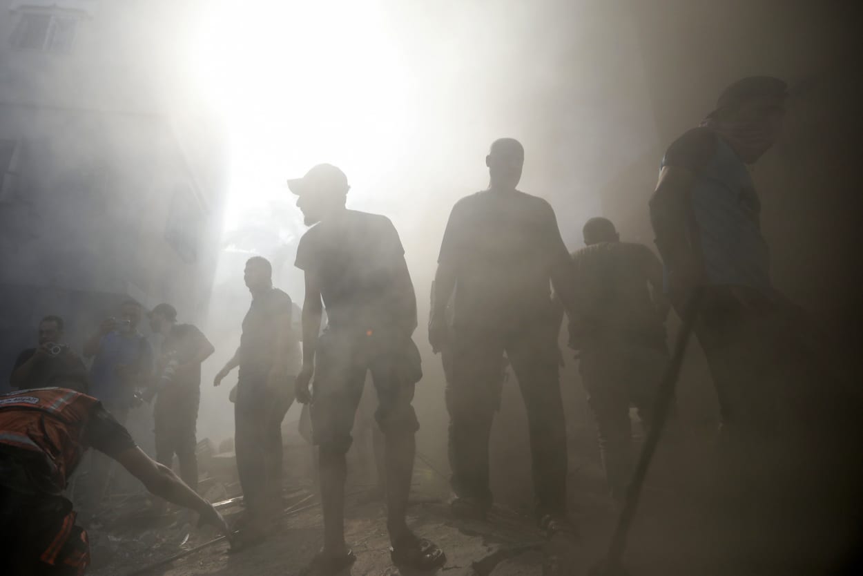 Palestinians look for survivors under the rubble of a destroyed building following an Israeli airstrike in Khan Younis refugee camp, southern Gaza Strip.