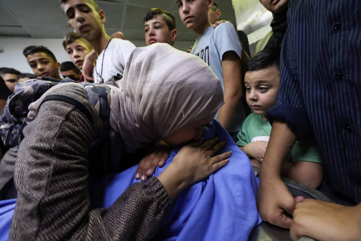 Family members grieve over the body of 14-year-old Hamdan Omer Hamdan at the Rafedia Hospital in Nablus, in the Israeli occupied West Bank.