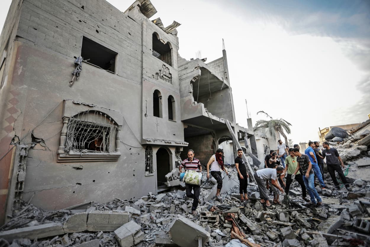 People search through destroyed buildings in Khan Younis in the southern Gaza Strip on Nov. 13, 2023.