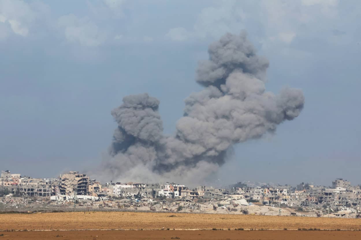 A large plum of smoke rises over the Gaza skyline.