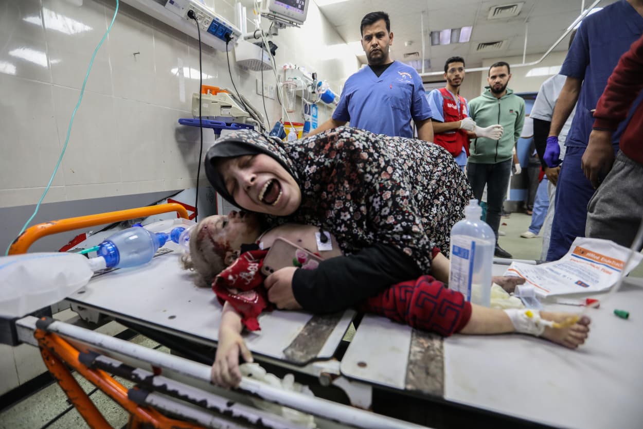 A mother hugs fifteen-month-old Nisreen Jundiyeh after she died from her injuries at a hospital in Khan Yunis on Dec. 20, 2023.