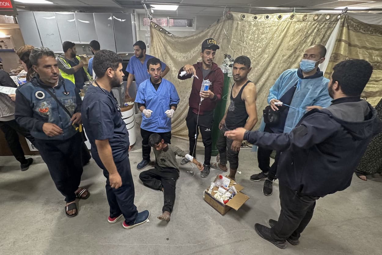 Medics care for an injured youth at Gaza's Al-Shifa hospital on Dec. 10, 2023.