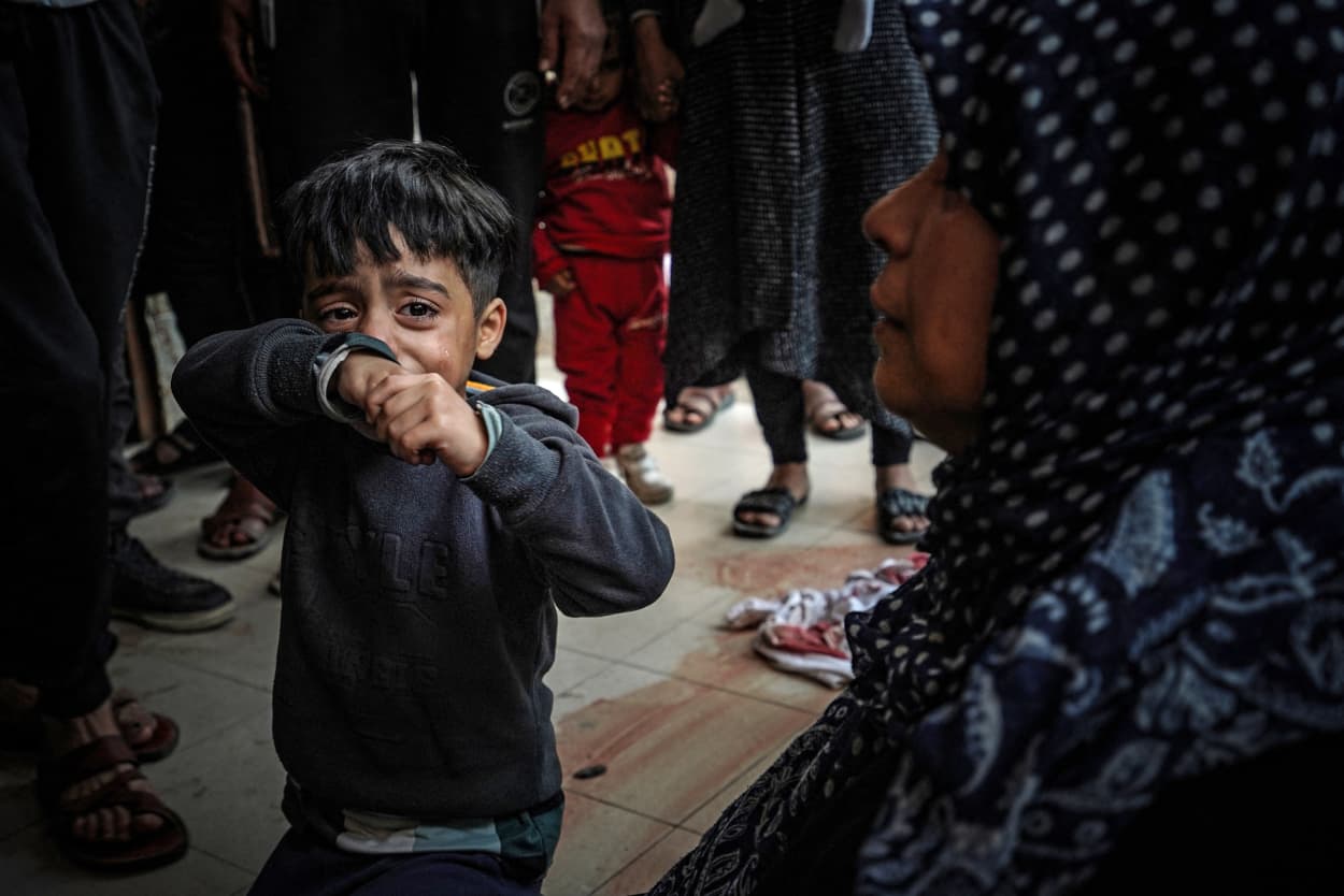 A child cries as people mourn loved ones at Nasser Hospital in Khan Younis, southern Gaza, on Dec. 27, 2023.