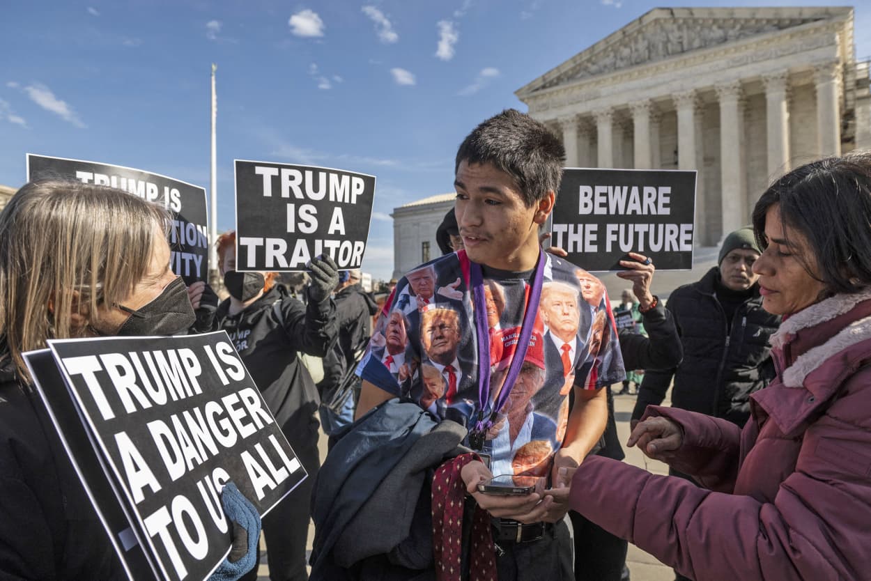 Trump supporter Gabriel Chambers speaks with anti-Trump demonstrators outside the Supreme Court on Feb. 8, 2024. 