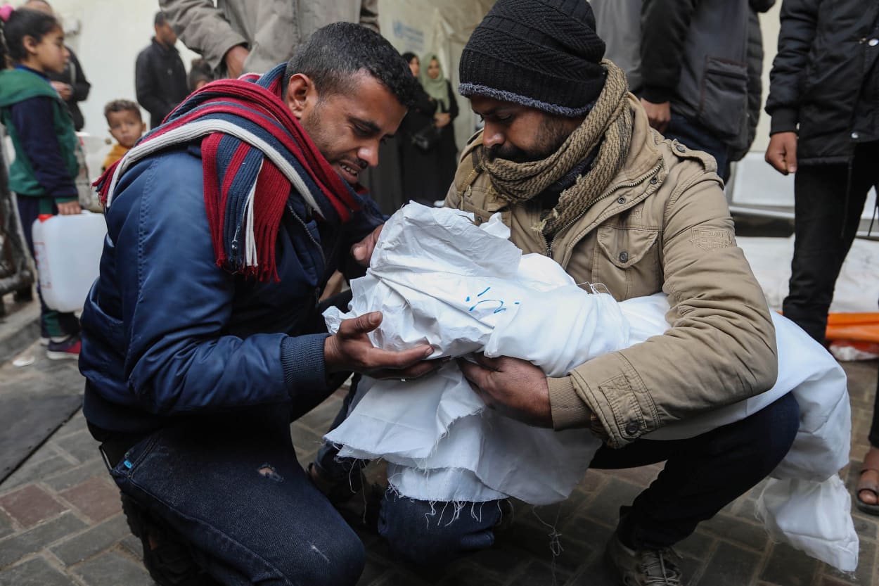 People mourn as they receive the bodies of victims of an Israeli strike.