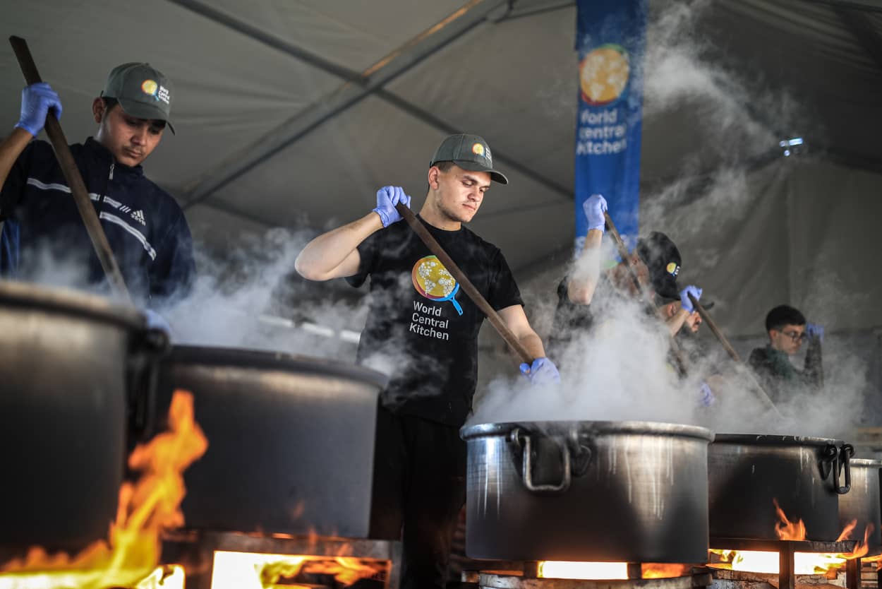 Volunteers of World Central Kitchen cook food for Palestinians in a mobile kitchen, in Rafah, Gaza