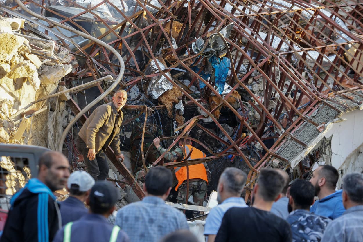 Emergency and security personnel inspect the rubble at the site of strikes which hit a building next to the Iranian embassy in Syria's capital Damascus, on April 1, 2024.