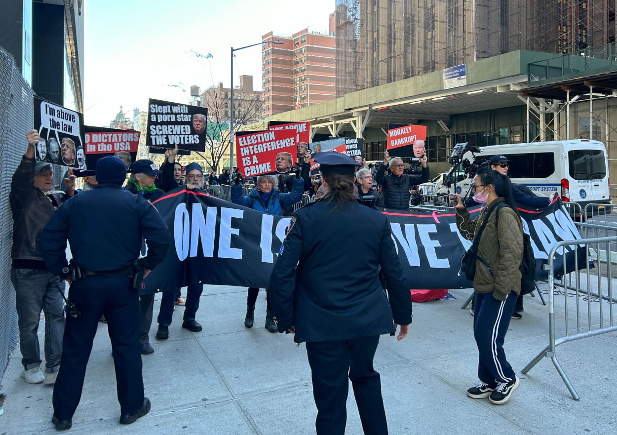 Anti-Trump protesters demonstrate Monday outside the Manhattan courthouse where the former president is on trial.