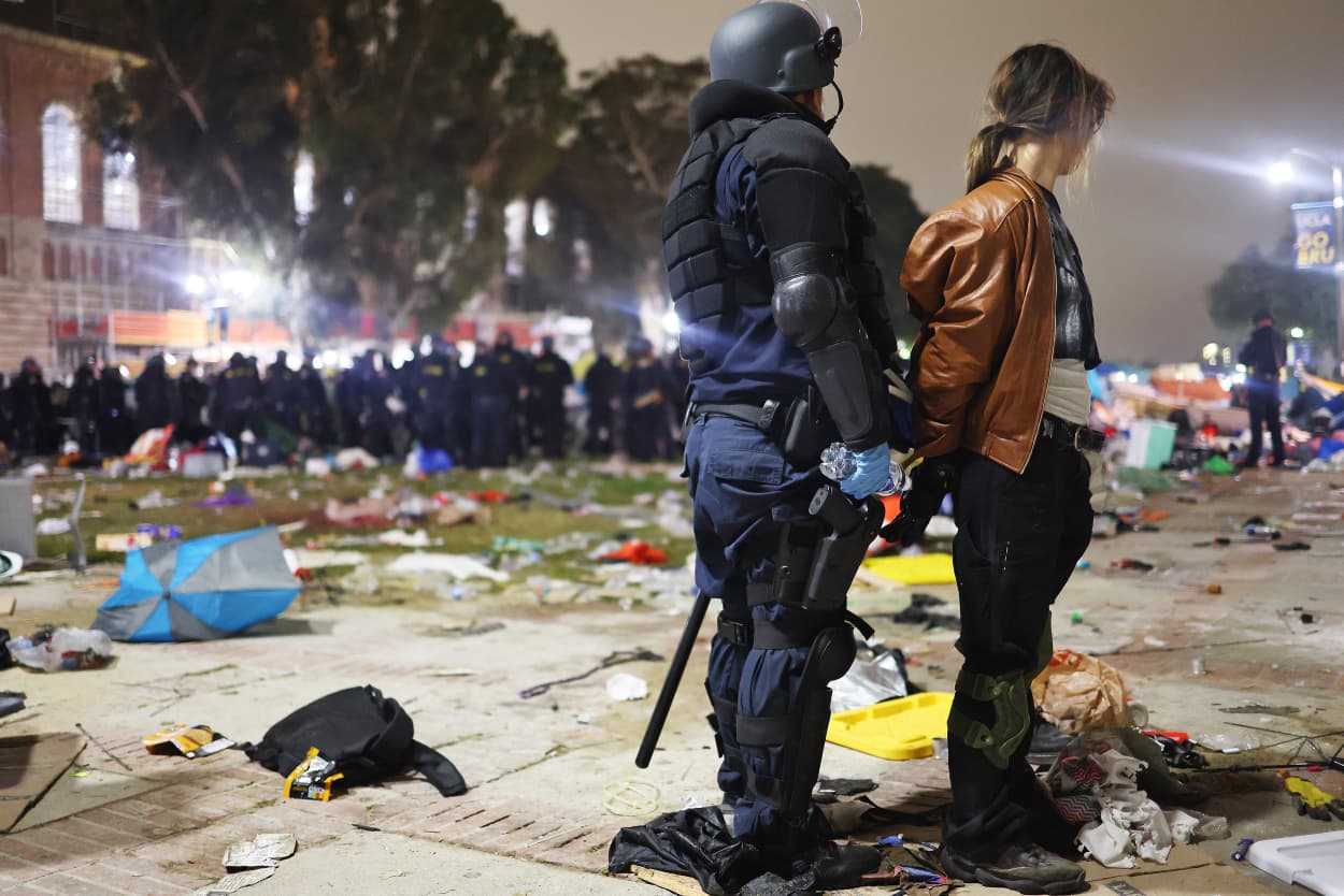 Police officer arrests a protester at UCLA