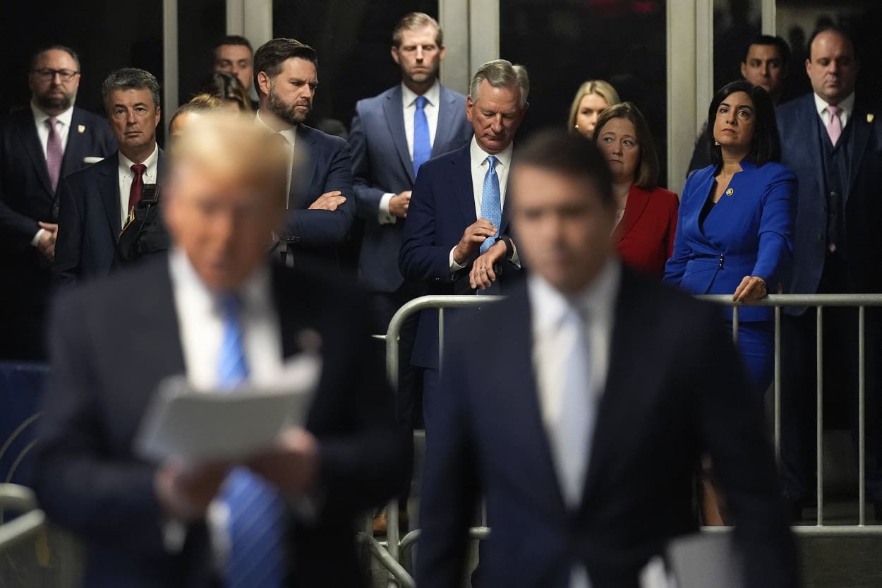 Alabama Attorney General, Steve Marshall, second from left, Sen. J.D. Vance, R-Ohio, Eric Trump, Sen. Tommy Tuberville, R-Ala., Iowa Attorney General Brenna Bird and Sen. Nicole Malliotakis, R-N.Y., listen as former President Donald Trump speaks ahead of court on May 13, 2024 in New York City.