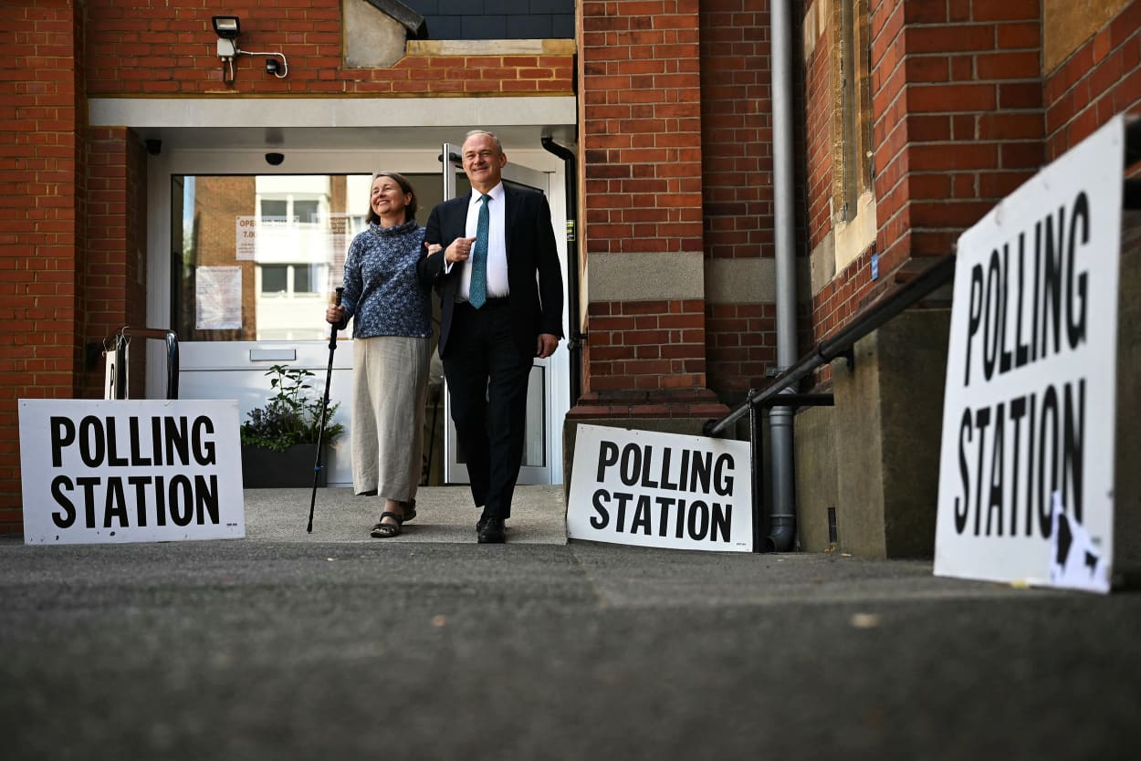 Britain's Liberal Democrats party leader Ed Davey leaves with his wife Emily after casting their votes at a polling station in London, on July 4, 2024.