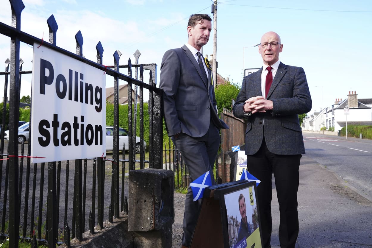 Scottish First Minister and SNP leader John Swinney stands with local parliamentary candidate Dave Doogan in Blairgowrie, Scotland, on July 4, 2024.