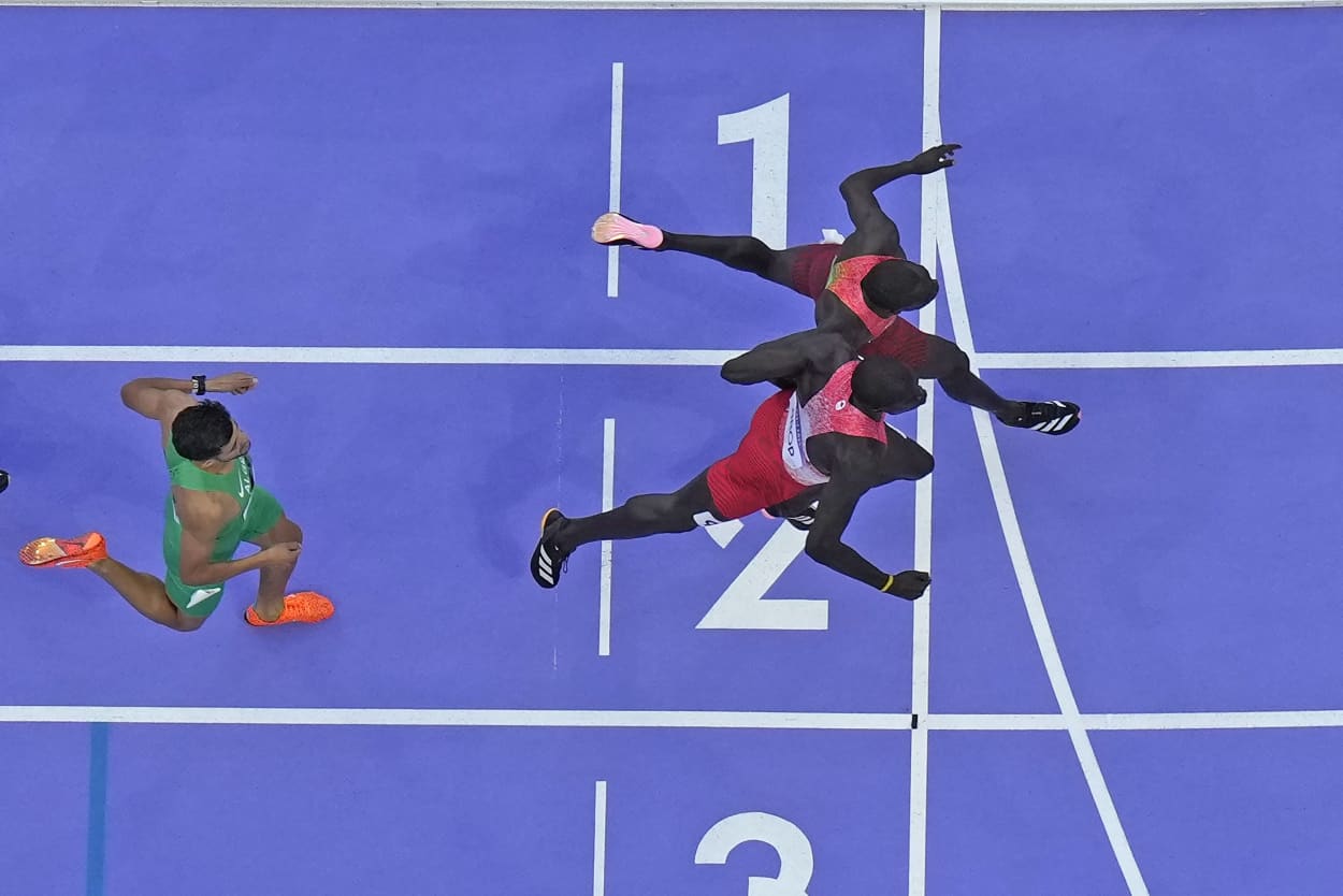 Emmanuel Wanyonyi, of Kenya, top, crosses the finish line ahead of Marco Arop, of Canada to win the men's 800-meter final.