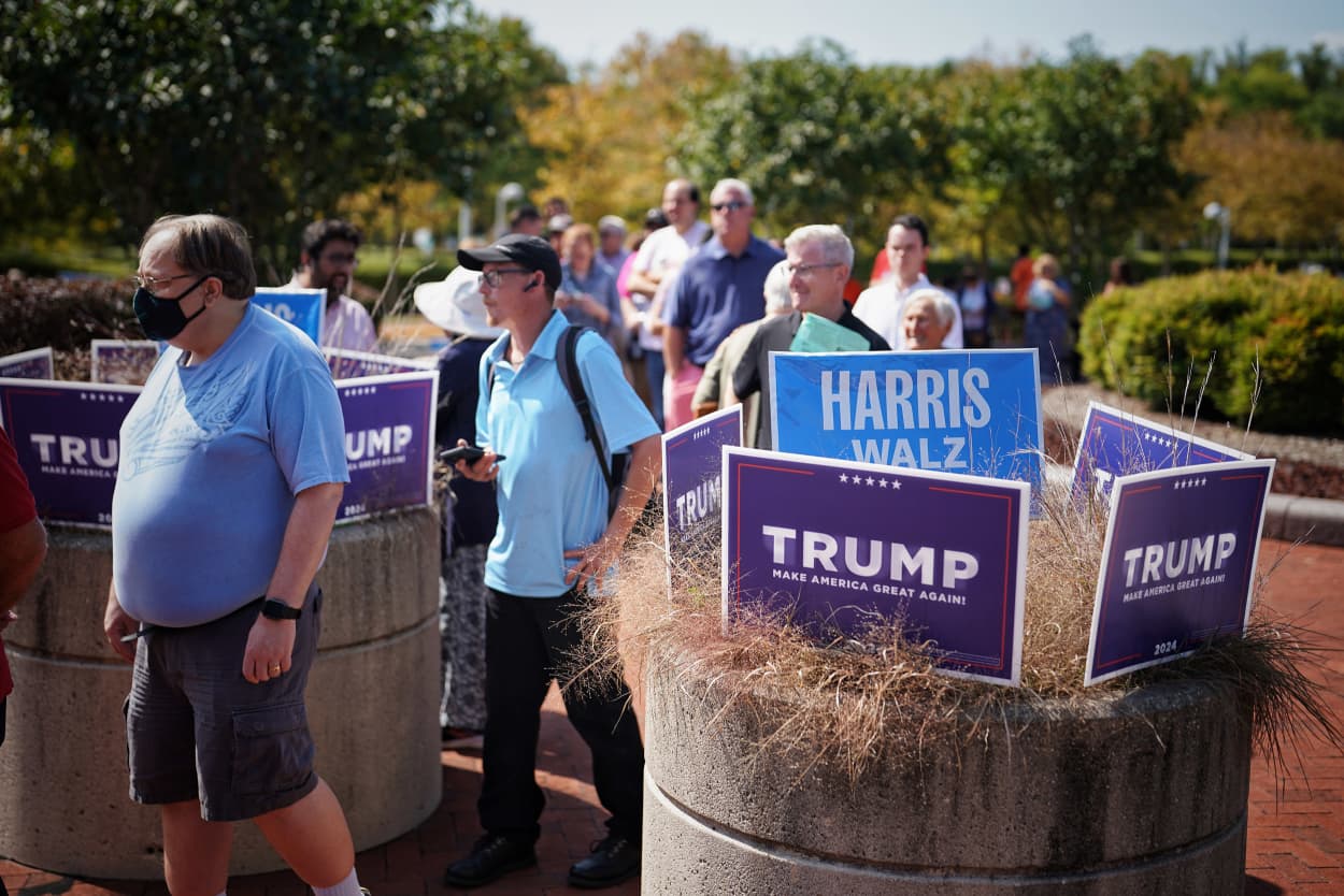 People wait in line to vote early on the first day of early voting in Virginia at a voting center in Fairfax, Va. 