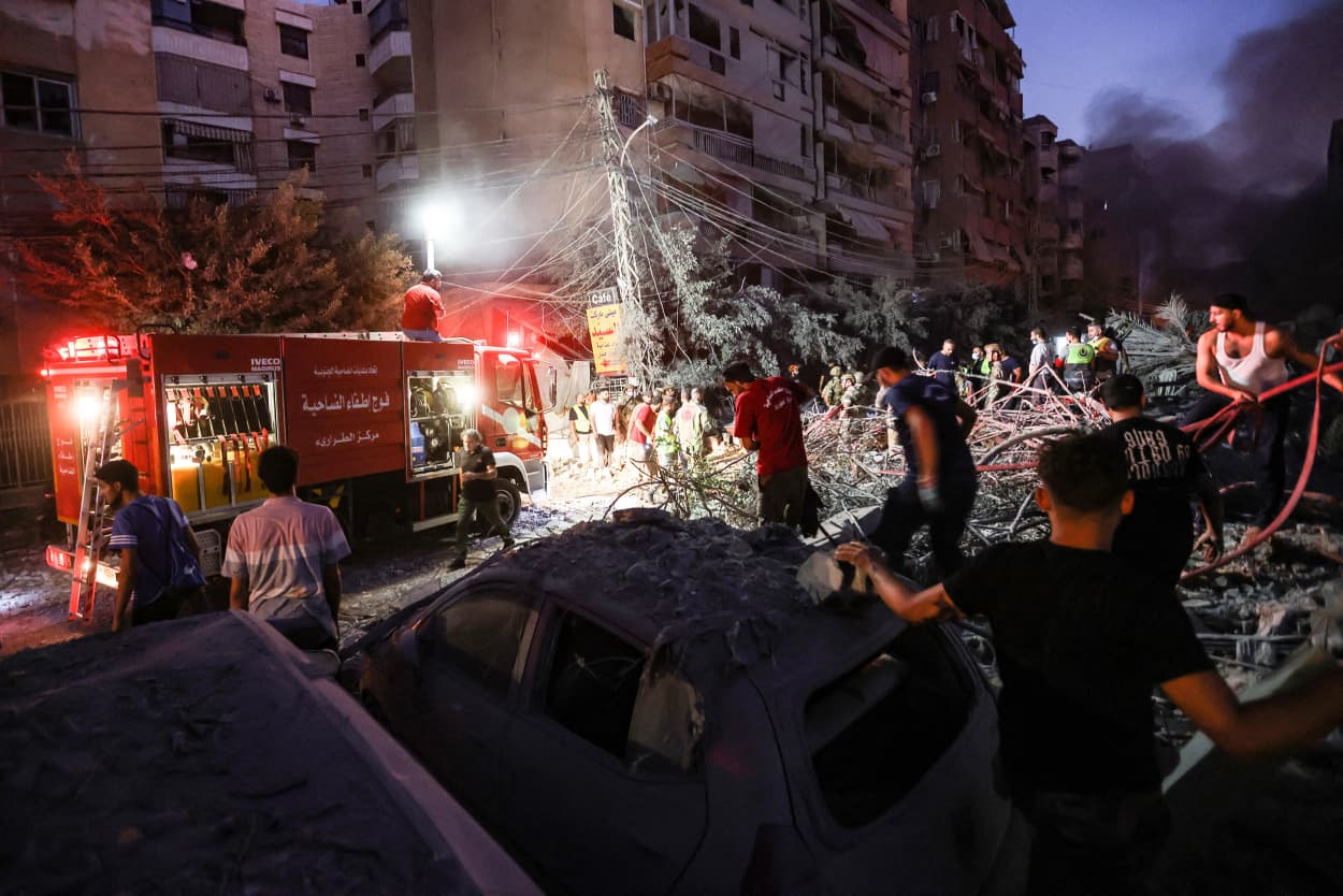 People and firefighters gather at the scene