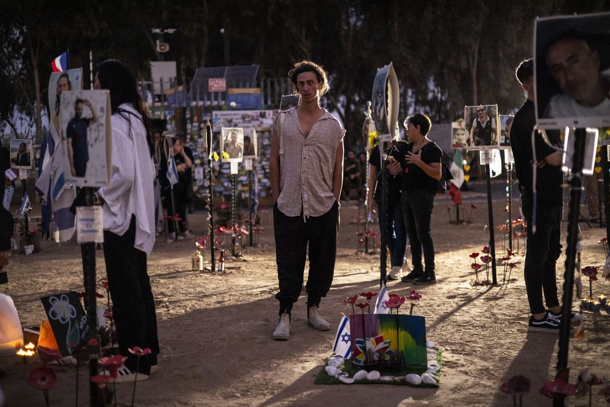 Mourners attend a vigil at the Nova Music Festival site in southern Israel on Oct. 7, 2024.