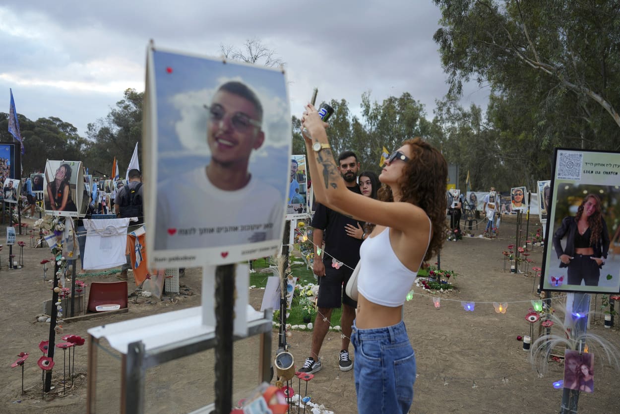 Mourners attend a vigil at the Nova Music Festival site in southern Israel on Oct. 7, 2024.