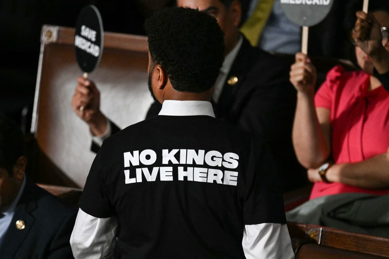 US Representative Maxwell Frost, Democrat from Florida, wears a shirt reading "No kings live here" as he walks out of the House Chamber while US President Donald Trump speaks during an address to a joint session of Congress at the US Capitol in Washington, DC, on March 4, 2025. 