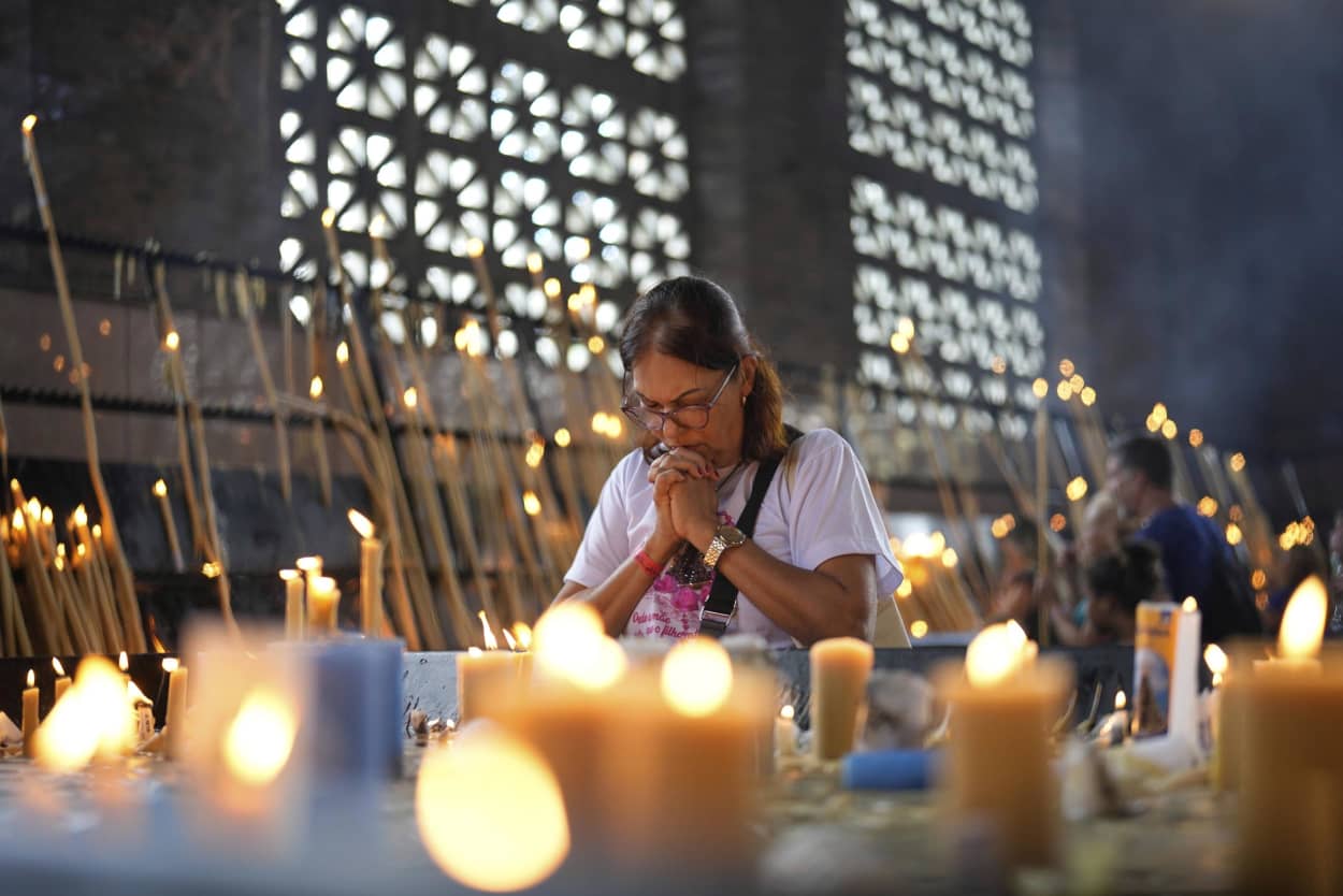 A woman prays at the National Sanctuary of Our Lady of Aparecida, following the Vatican’s announcement of Pope Francis’ death, in Aparecida, Brazil, Monday, April 21, 2025. 