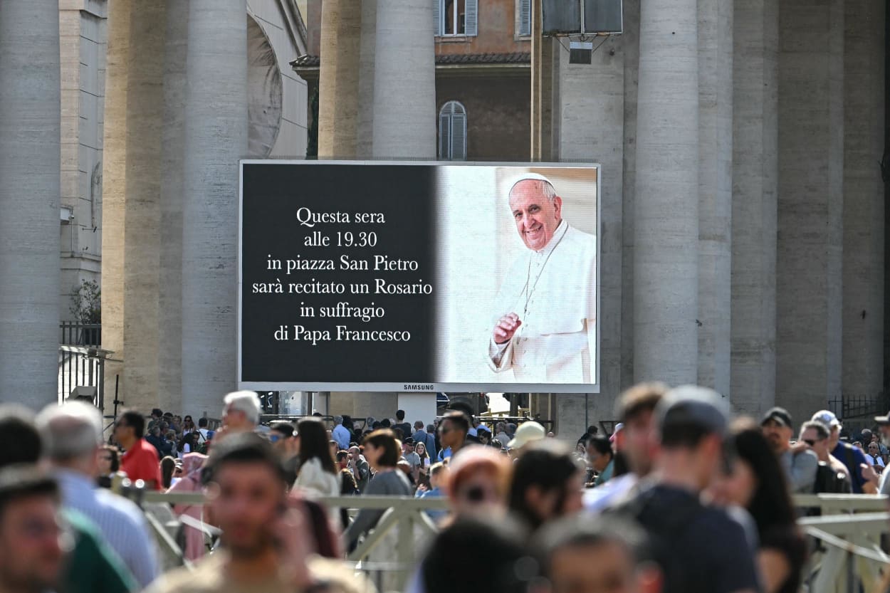 A screen in St. Peter's Square on April 21, 2025, announces that a Rosary will be recited this evening in suffrage of Pope Francis.