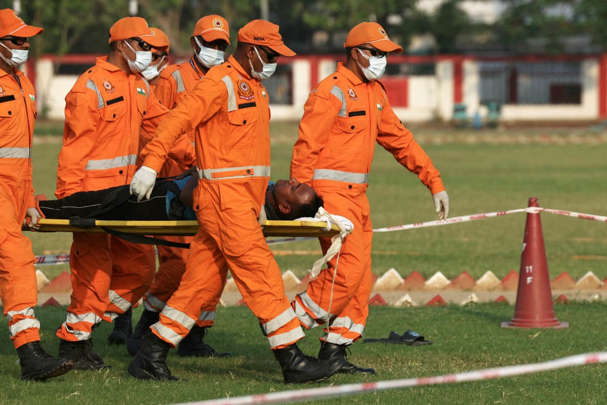 National Disaster Response Force (NDRF) personnel take part in the nationwide civil defence mock drill in Varanasi.