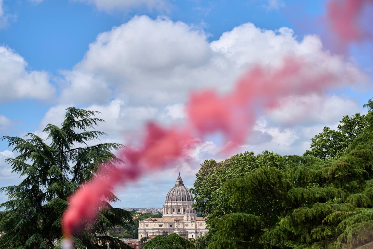 Pink smoke rises in front of St. Peter's Dome