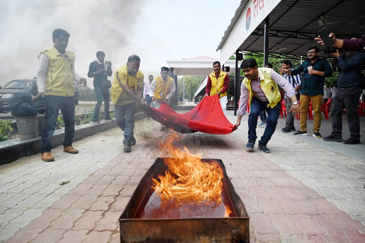 Officials attend to a planned fire during a security drill in Lucknow, India.