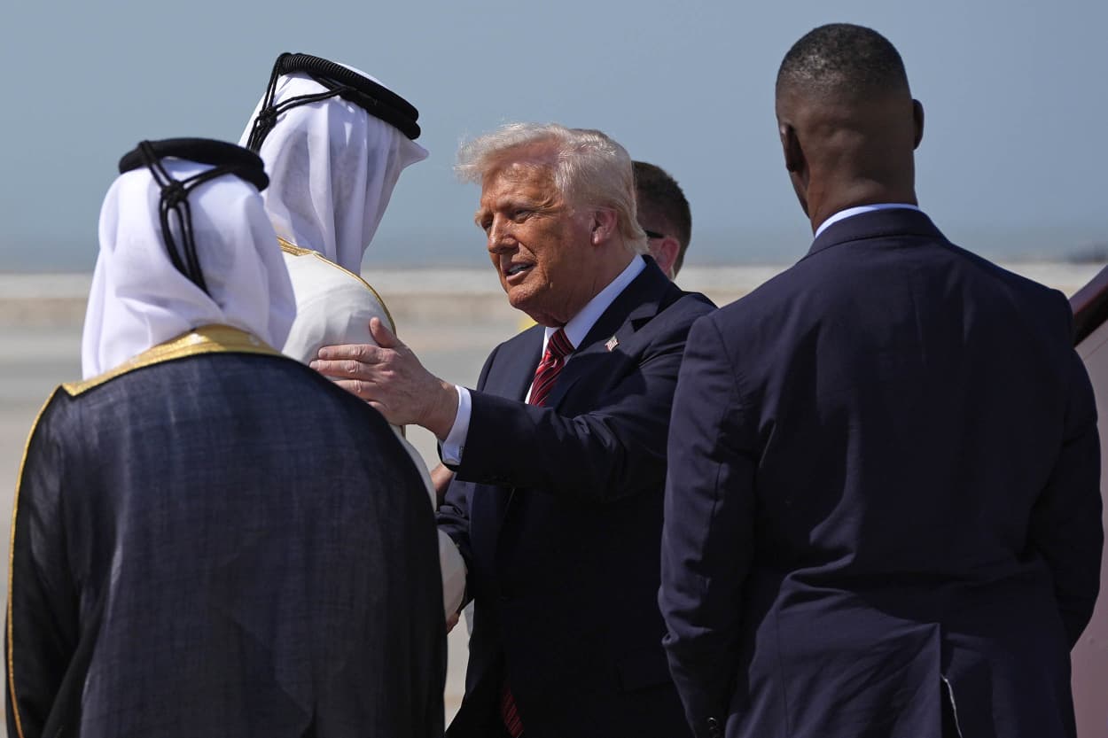 President Donald Trump is greeted by Qatar's Emir Sheikh Tamim bin Hamad Al Thani
