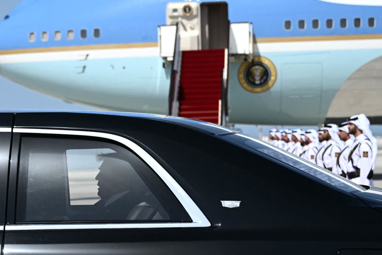 Trump in car with Air Force One plane in the background