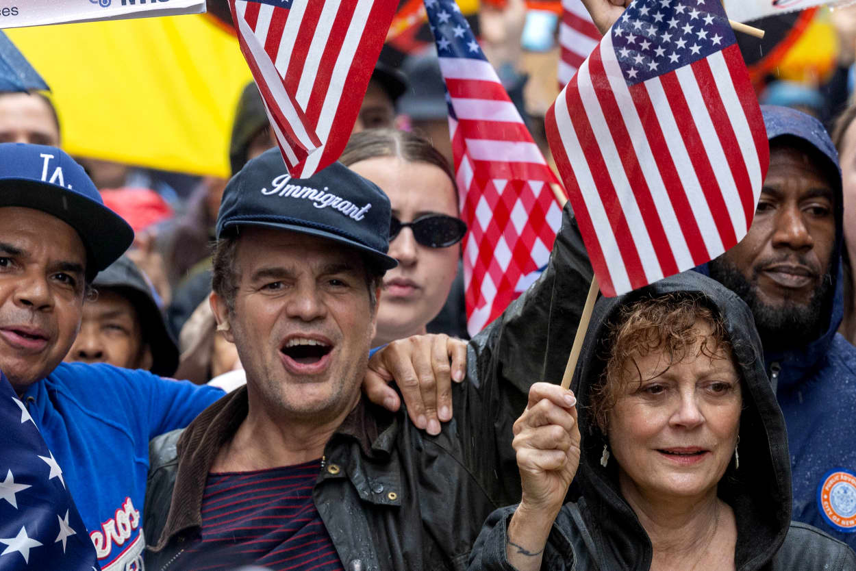 Image: Mark Ruffalo, Susan Sarandon and other protesters hold flags in New York.