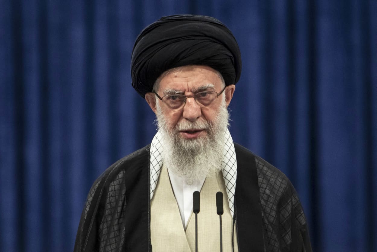 Iran's supreme leader Ayatollah Ali Khamenei speaking into a microphone