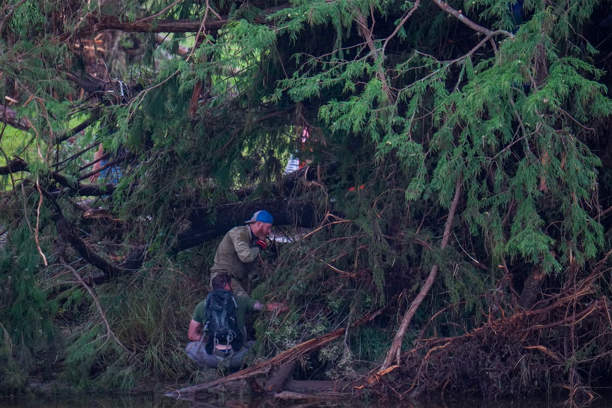 Officials search on the grounds of Camp Mystic along the banks of the Guadalupe River after a flash flood swept through the area Sunday, July 6, 2025, in Hunt, Texas.