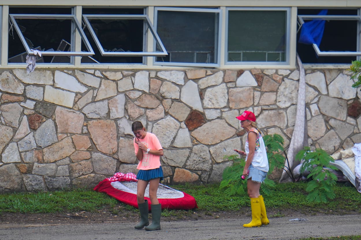 People react as they inspect an area outside sleeping quarters at Camp Mystic along the banks of the Guadalupe River after a flash flood swept through the area Sunday, July 6, 2025, in Hunt, Texas.