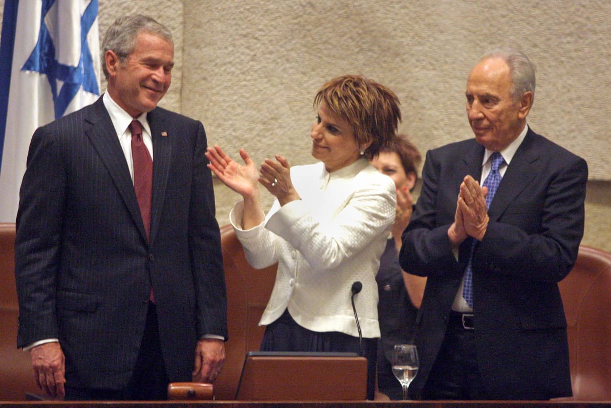 President George W. Bush smiles as Israeli Parliament Speaker Dalia Itzik and President Shimon Peres applaud following his address to Israel's parliament on May 15, 2008.