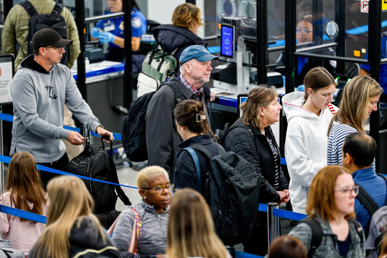 Travelers wait in line.