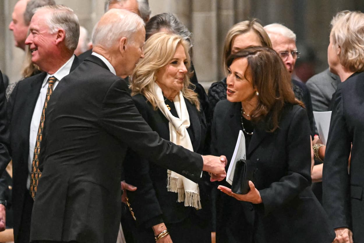Former U.S. President Joe Biden greets former U.S. Vice President Kamala Harris.
