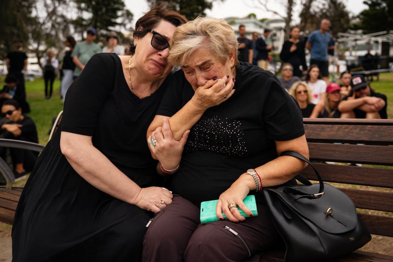 Mother and daughter, Jana and Ella embrace while gathering at Bondi Pavilion