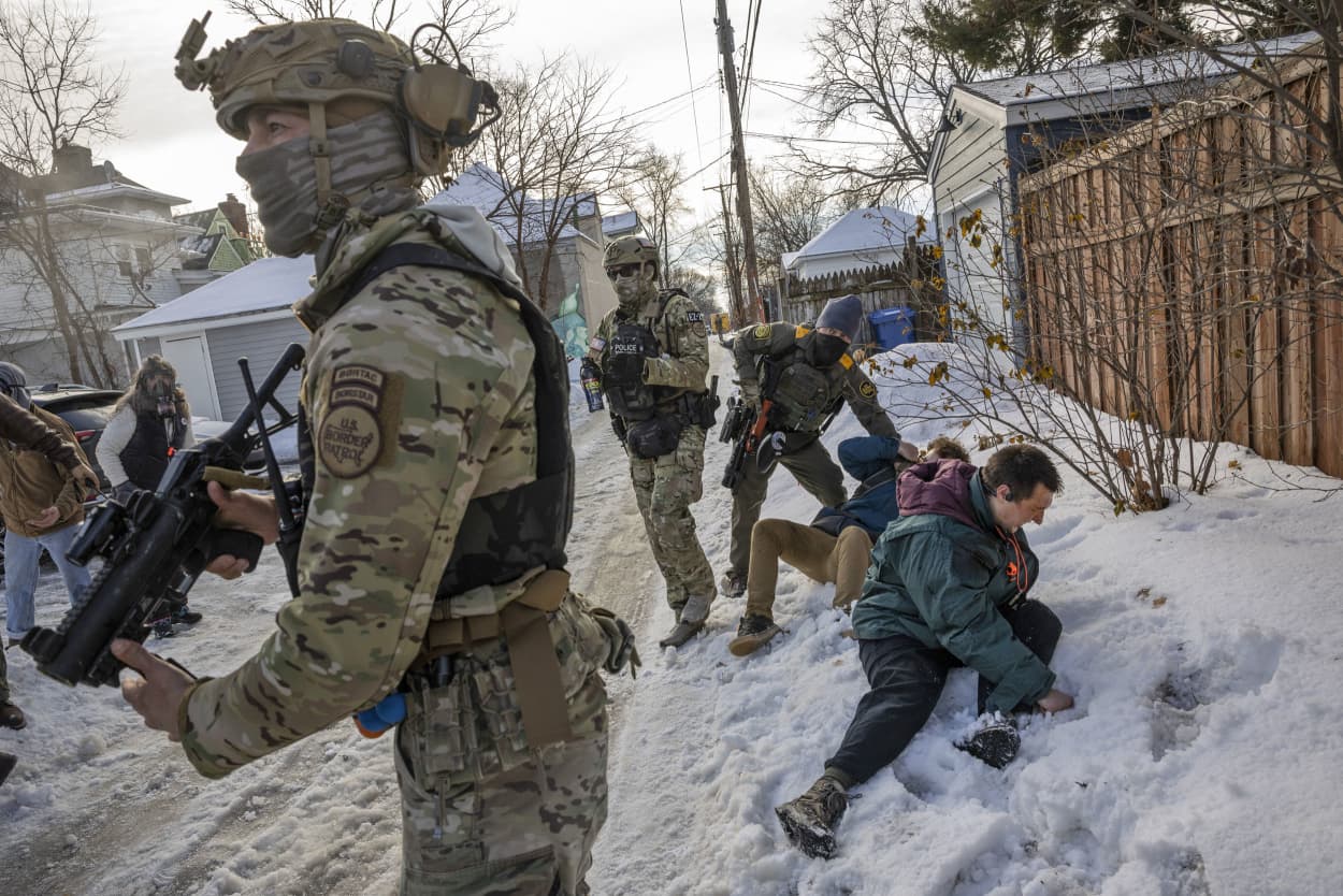 Members of the U.S. Border Patrol shove men to the ground as federal agents try to leave the scene of a shooting involving a federal immigration officer in Minneapolis, on Wednesday, Jan. 7, 2026. 